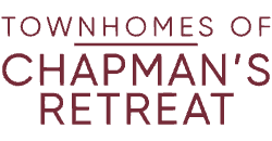 A green sign with red lettering that says "Townhomes of Chapman